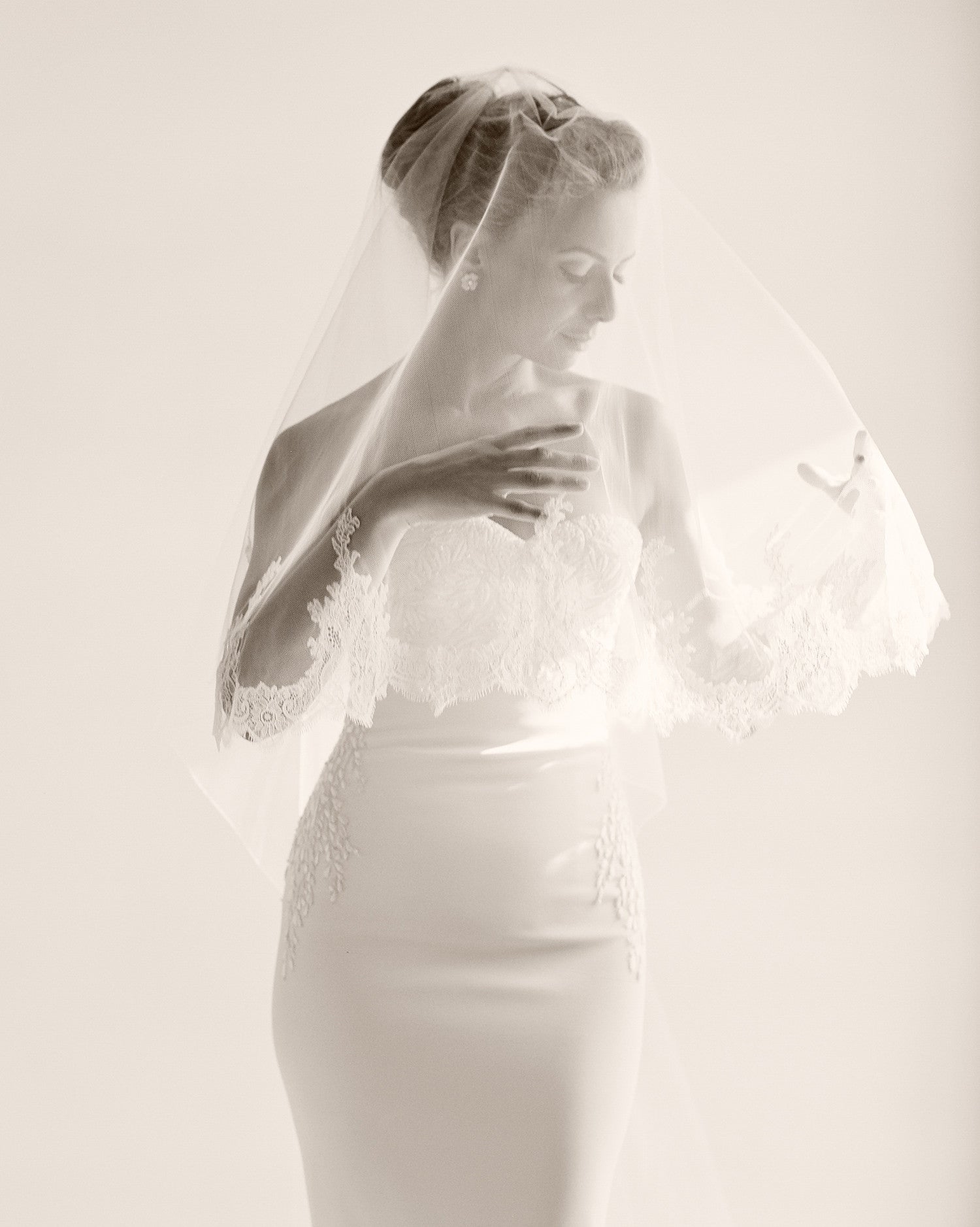 Sepia image of glamours bride, form fitting dress creates a beautiful silhouette. 