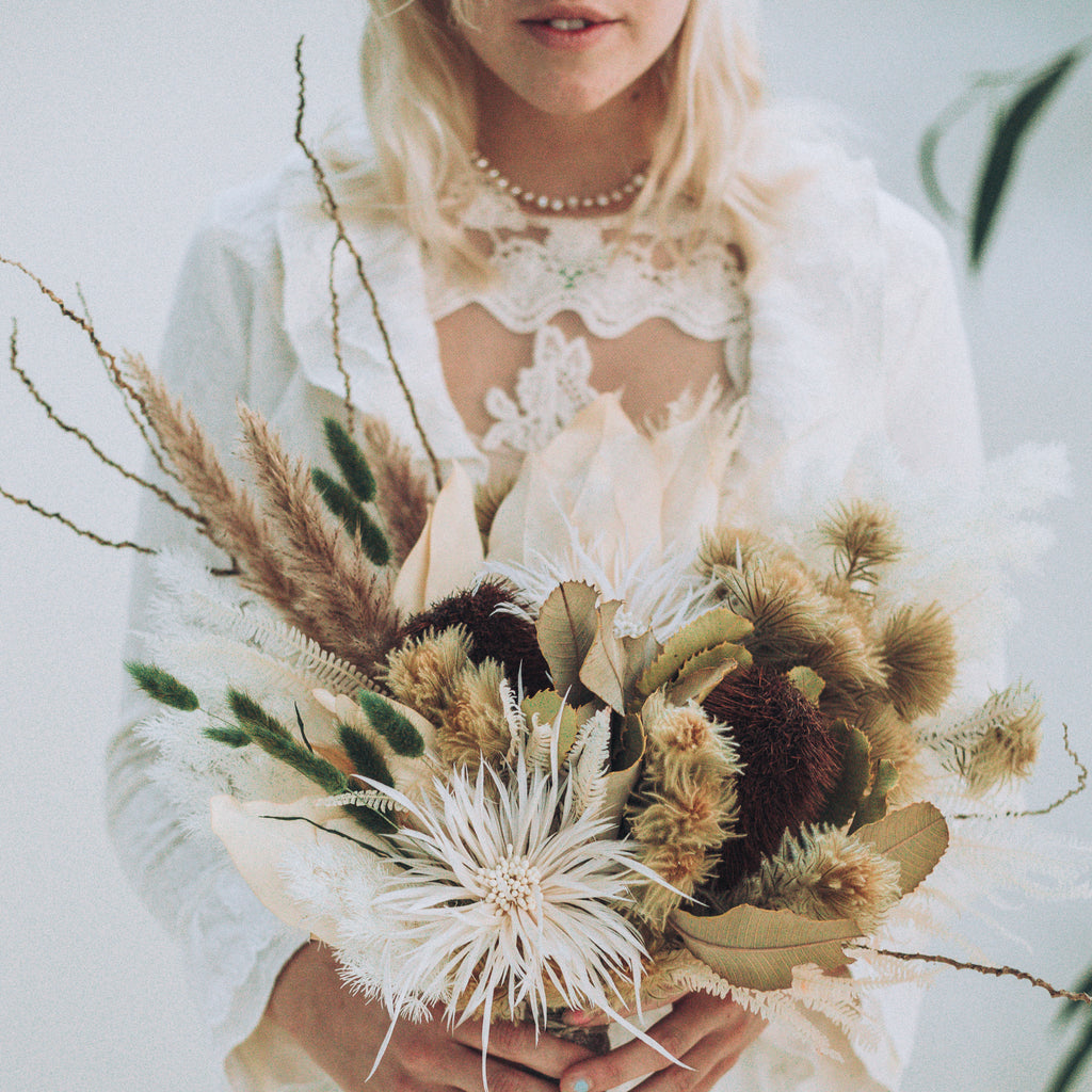 bride presenting beautiful dried flowers