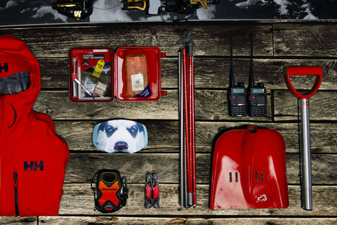 gogglesoc goggle cover ready for an adventure, shown alongside other ski gear including avalanche kit and a ski jacket