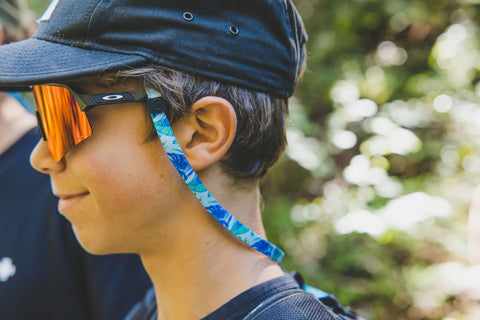 sunnystring eyewear retainer being worn by someone on a hike in the mountains