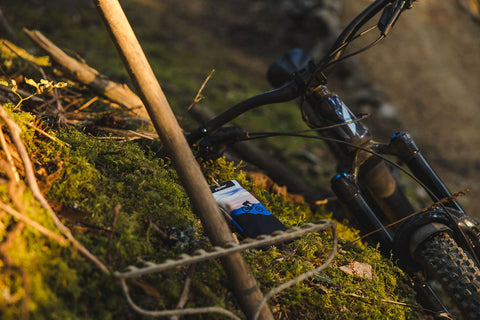 sunnysoc sunglass pouch on a mountain bike trail near a mountain bike