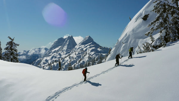 skier ski touring in the backcountry with gogglesoc goggle cover