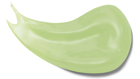 A green-coloured smear of a natural face moisturizer containing squalane oil