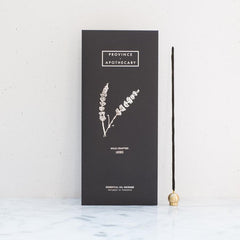 Lavender essential oil incense in a black package by Province Apothecary against a white background.