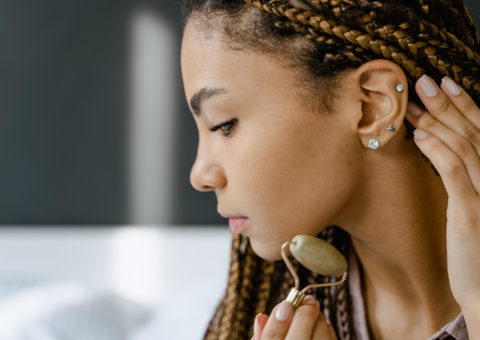 Woman using jade facial roller