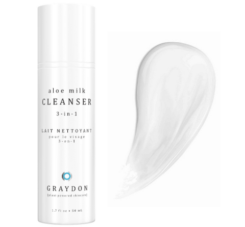 A soothing milk cleanser for sensitive skin next to a smear of the white-coloured cleanser against a white background.