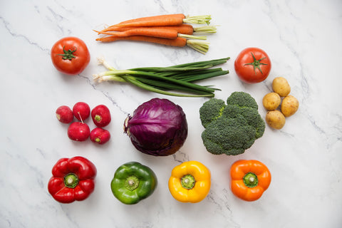 A healthy assortment of vegetables on a beautiful marble counter.
