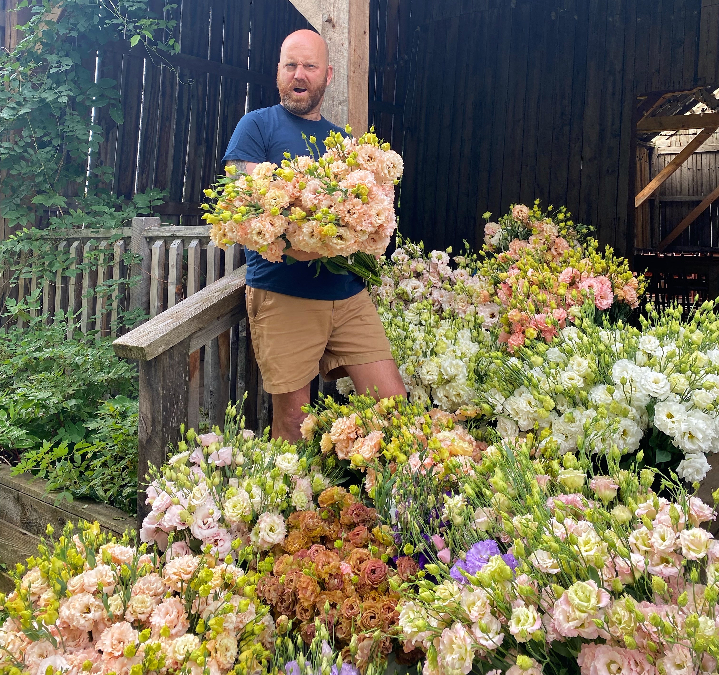 Farmer Bailey Hale in the party barn at ardelia farm surrounded by thousands of  lisianthus blooms