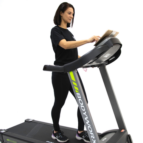 Woman using Ipad on treadmill