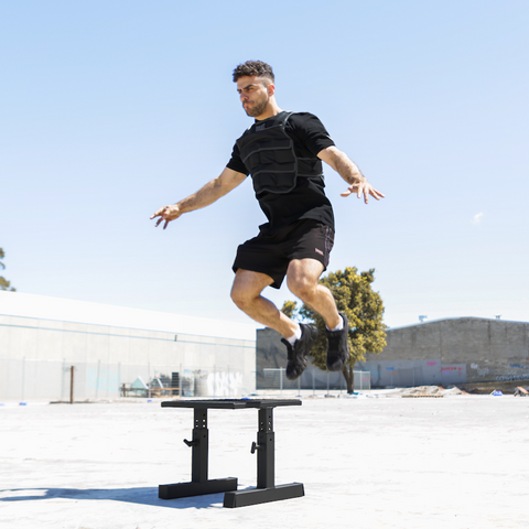 Man doing box jump on steel plyo box