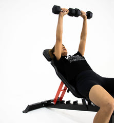female doing dumbbell incline chest press on adjustable weight bench