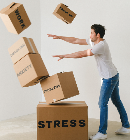 man pushing over boxes of stress