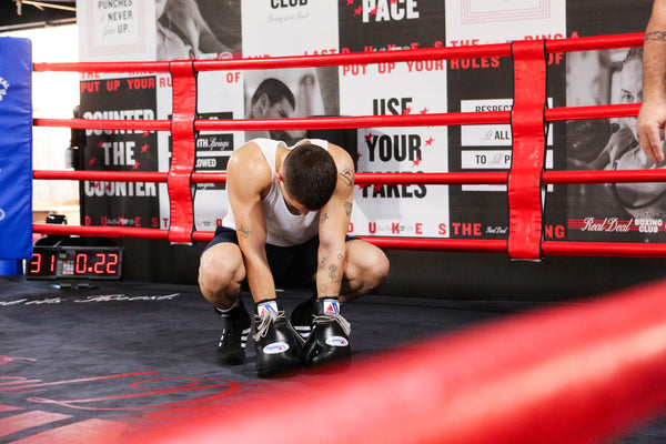 Man resting in boxing ring