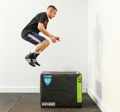 Man doing box jump on foam plyo box