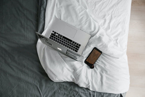 laptop & phone in bed