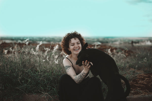 A woman enjoying her time with her black dog