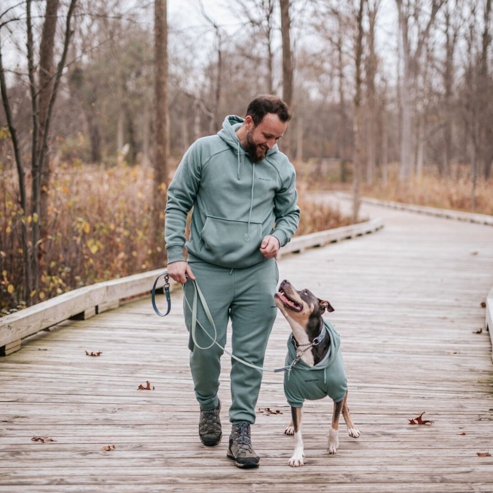 Man walking his dog all wearing matching Sparkpaw's hoodies