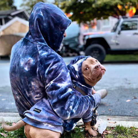 Pit bull and owner with matching hoodies.