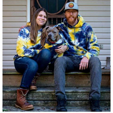Pitbull and owners wearing matching Sparkpaws hoodie sets