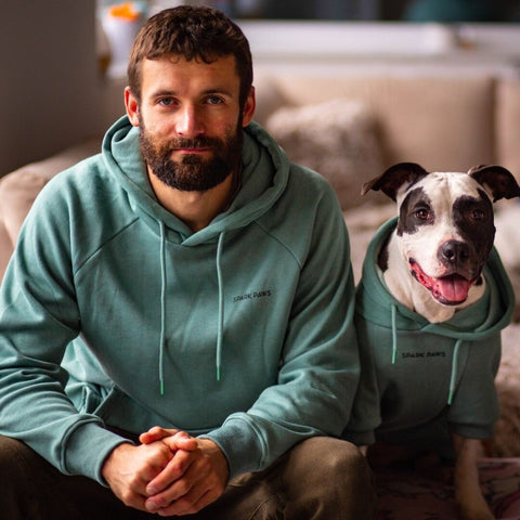 Owner and pup in matching Sparkpaw hoodies