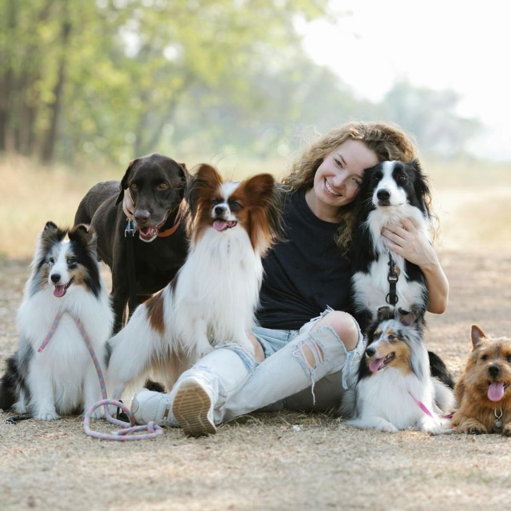 Woman socializing with her dogs at the park