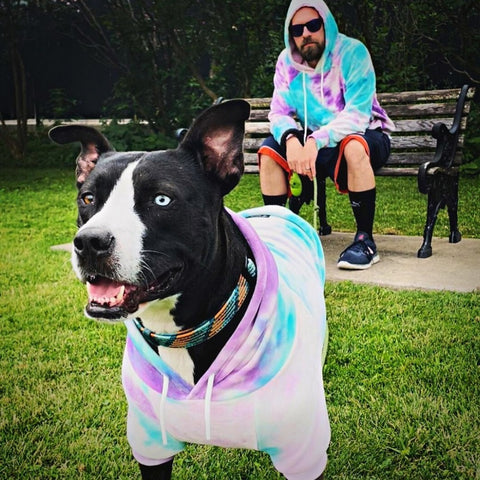 A man and his dog in matching outfits