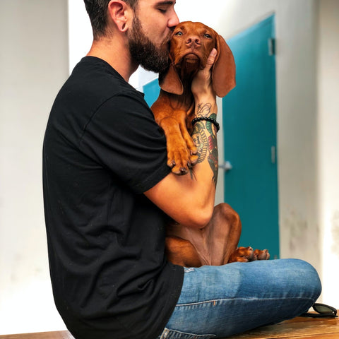 Man giving his dog a kiss