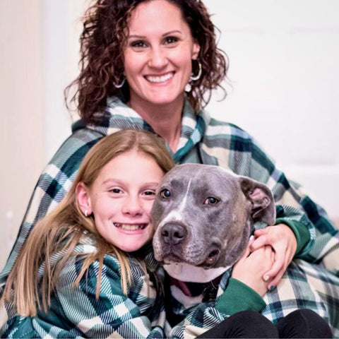 a family wearing the same outfits as their pit bull