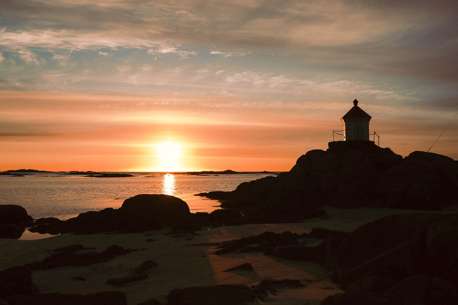 Midnight sun over beach in Lofoten, Norway