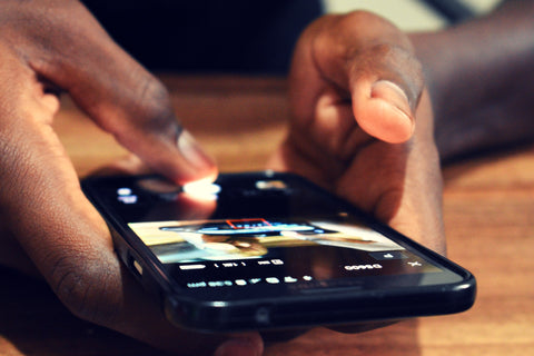 Cell phone in hand being used close-up