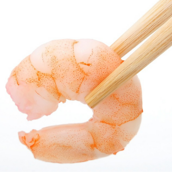 a pair of chopsticks holding a cooked shrimp