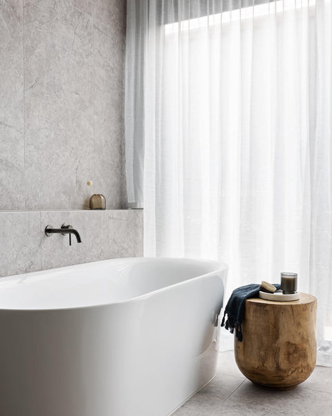 Elegant sheer curtains over the bathroom window