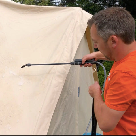 Man spraying canvas bell tent