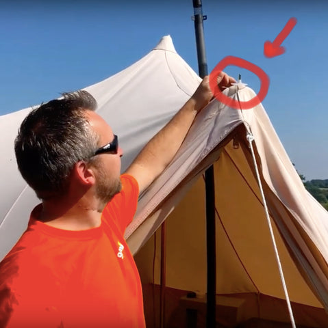 James pointing at the rain caps on the top of the glawning a-frame