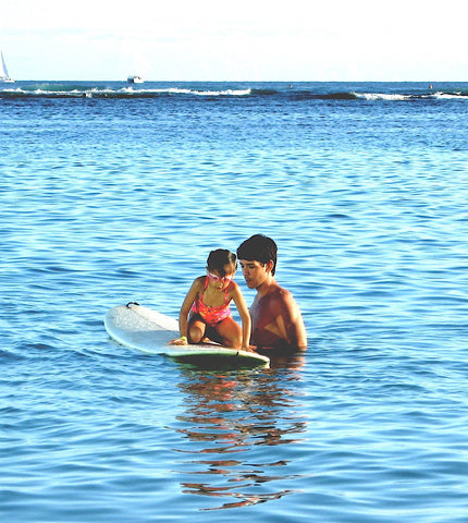 Dad and daughter surfing