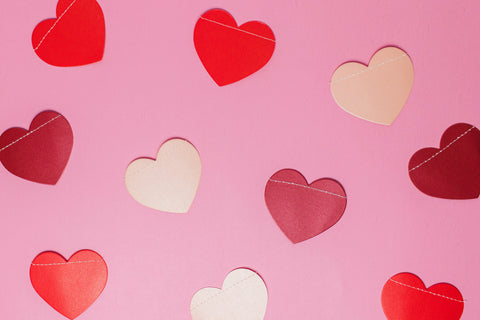 Paper hearts on a pink background - Valentine's Day