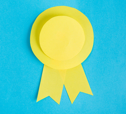 Yellow ribbon on blue background - Tip #1: Give prizes for lots of different things