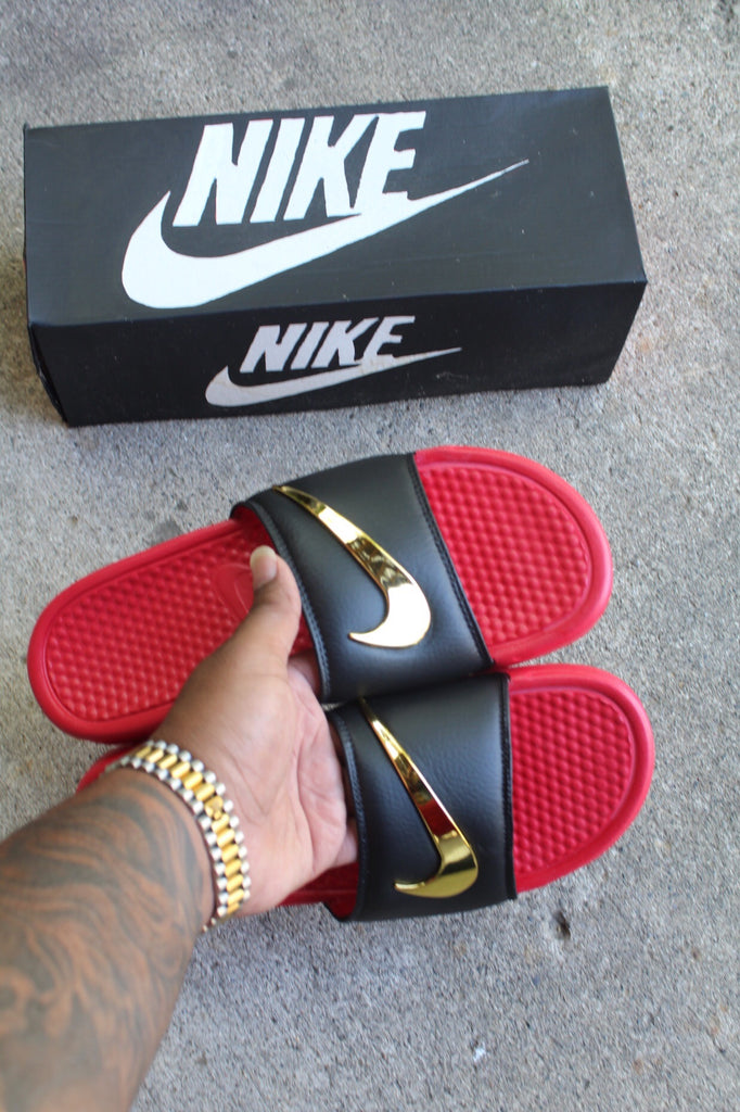 red nike slides with gold swoosh
