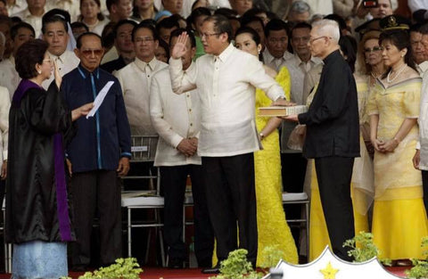 Aquino is sworn in at his inauguration at Quirino grandstand. He wears a Barong Tagalog