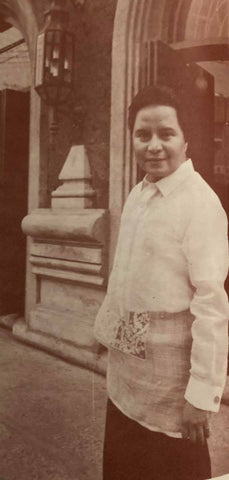 Designer Edgar Aquino in his own piña Barong Tagalog standing in front of his Ermita shop.