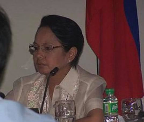 Arroyo wears a short sleeve barong while in this Joint Cabinet and National Disaster Coordinating Council meeting