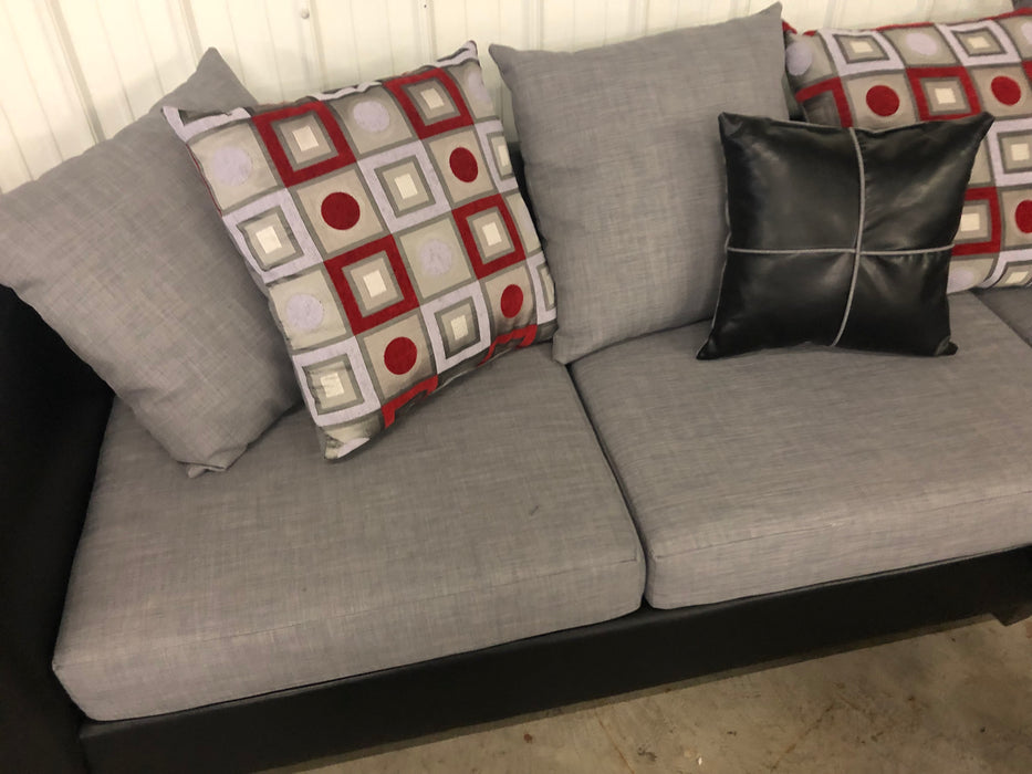 Anderson Sofa And Loveseat Set In Gray And Black With Black And Red Accent Pillows