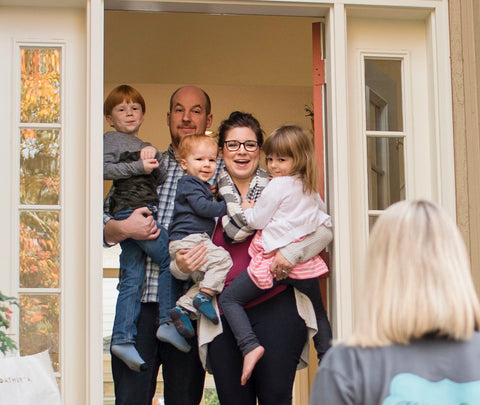 With Love Oregon - Family with three children smiling in their doorway