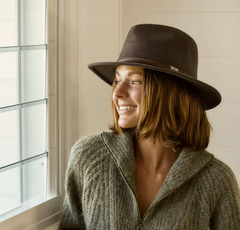 Woman wearing a dark brown crushable wool outback hat and a sweater