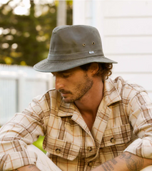 man wearing a flannel shirt and a cotton fishing hat