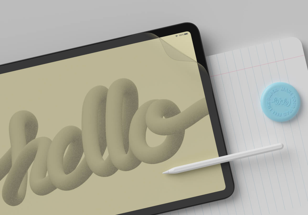 Image of an iPad with a drawing of the word “hello” on it, laying on a lined sheet of paper with an Apple Pencil.