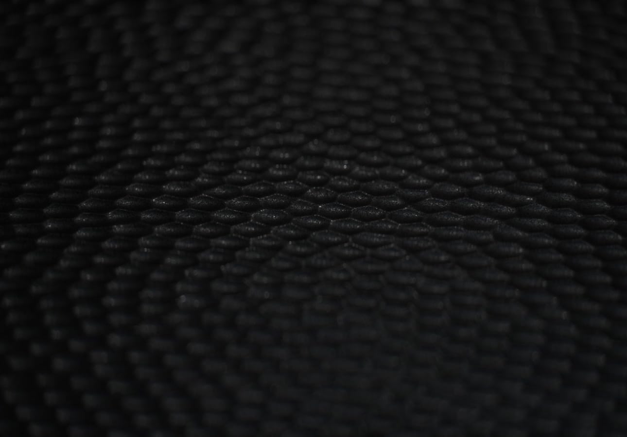 Close-up view of a nano-texture glass surface, showing a highly detailed, densely packed pattern of tiny, circular bumps.