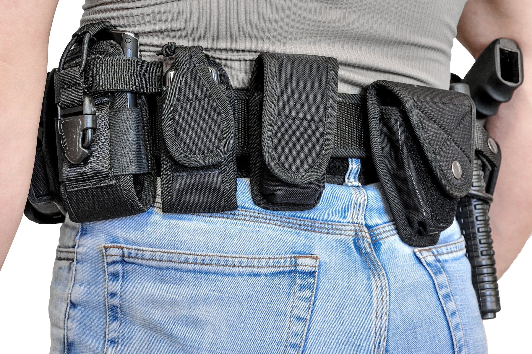 Person wearing a tactical belt with various accessories attached