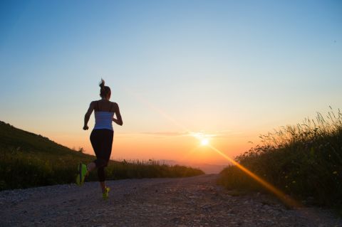 Woman jogging safely at sun set with an IWB holster