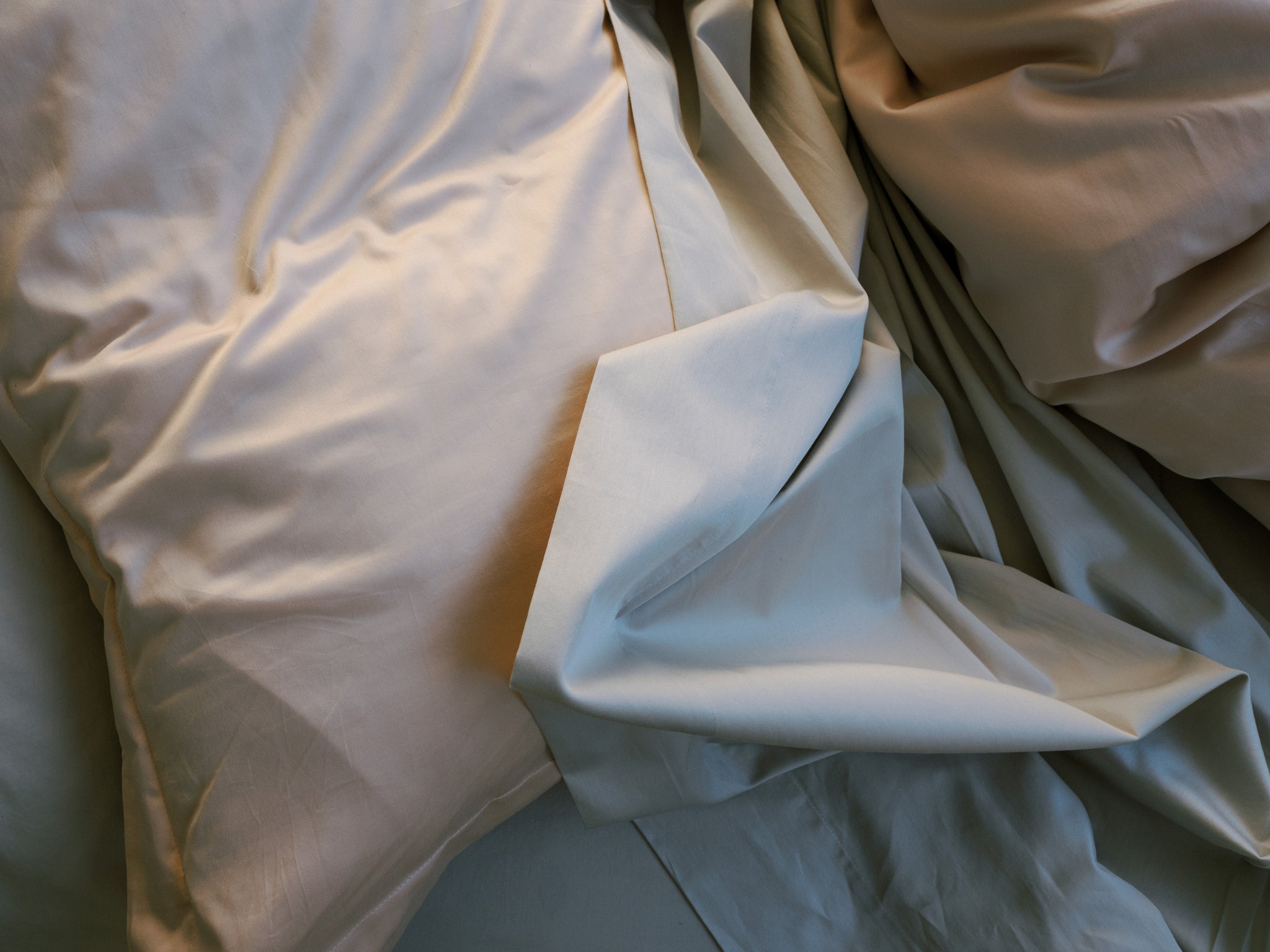 Layered bedding in soothing shades for a touch of luxury